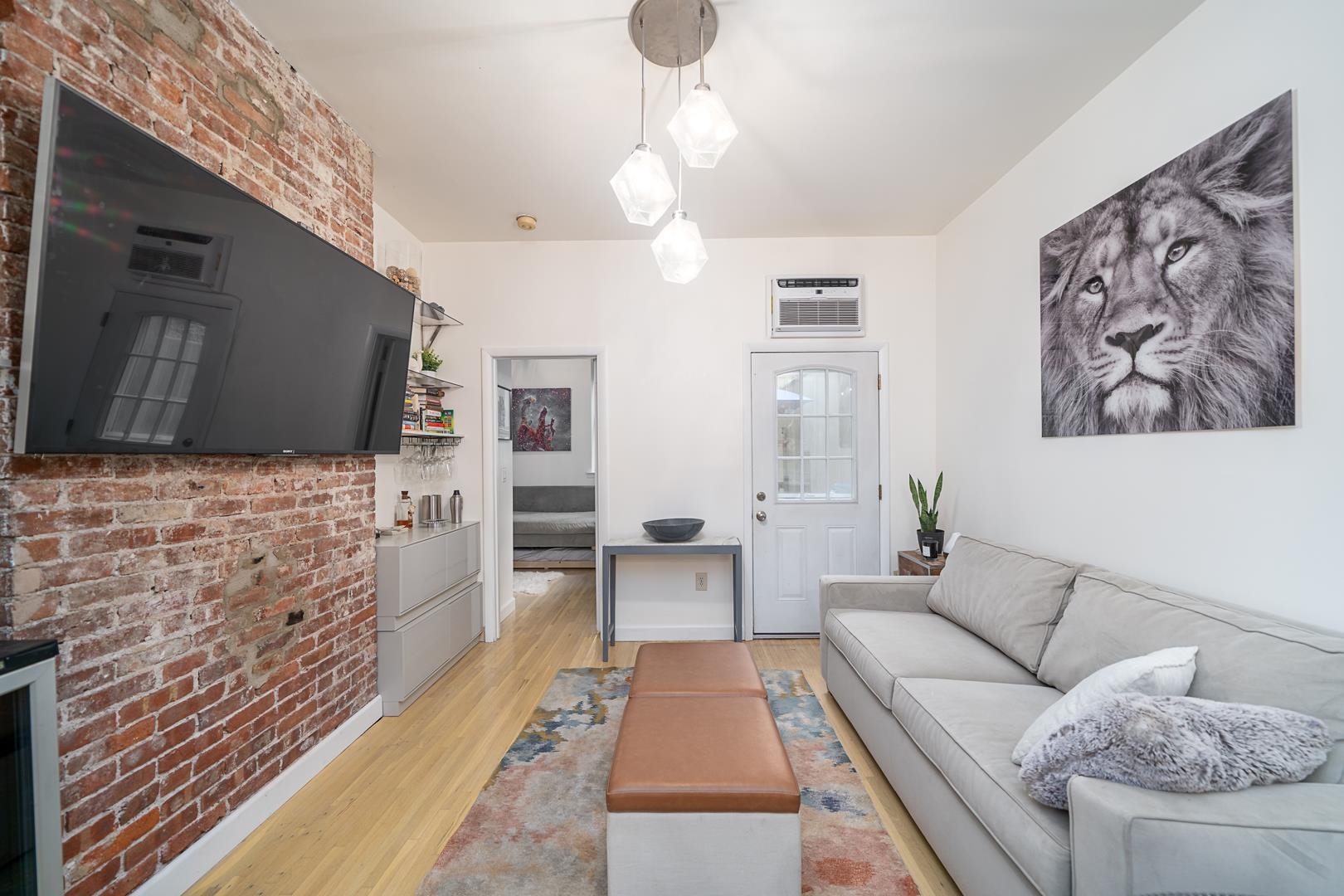 554 Observer Highway, Unit 1R Hoboken, NJ 07030 - Photo 3 of 21 a living room with furniture and a flat screen tv