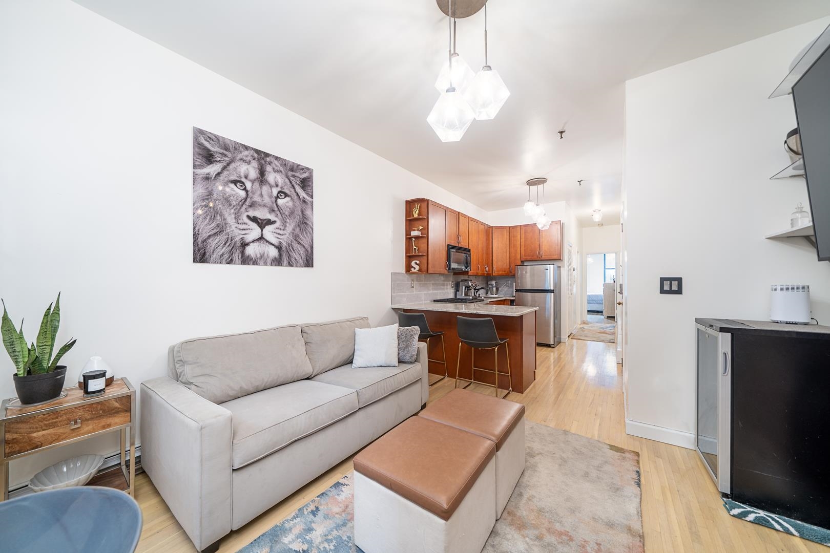 554 Observer Highway, Unit 1R Hoboken, NJ 07030 - Photo 5 of 21 a living room with furniture a flat screen tv and a fireplace