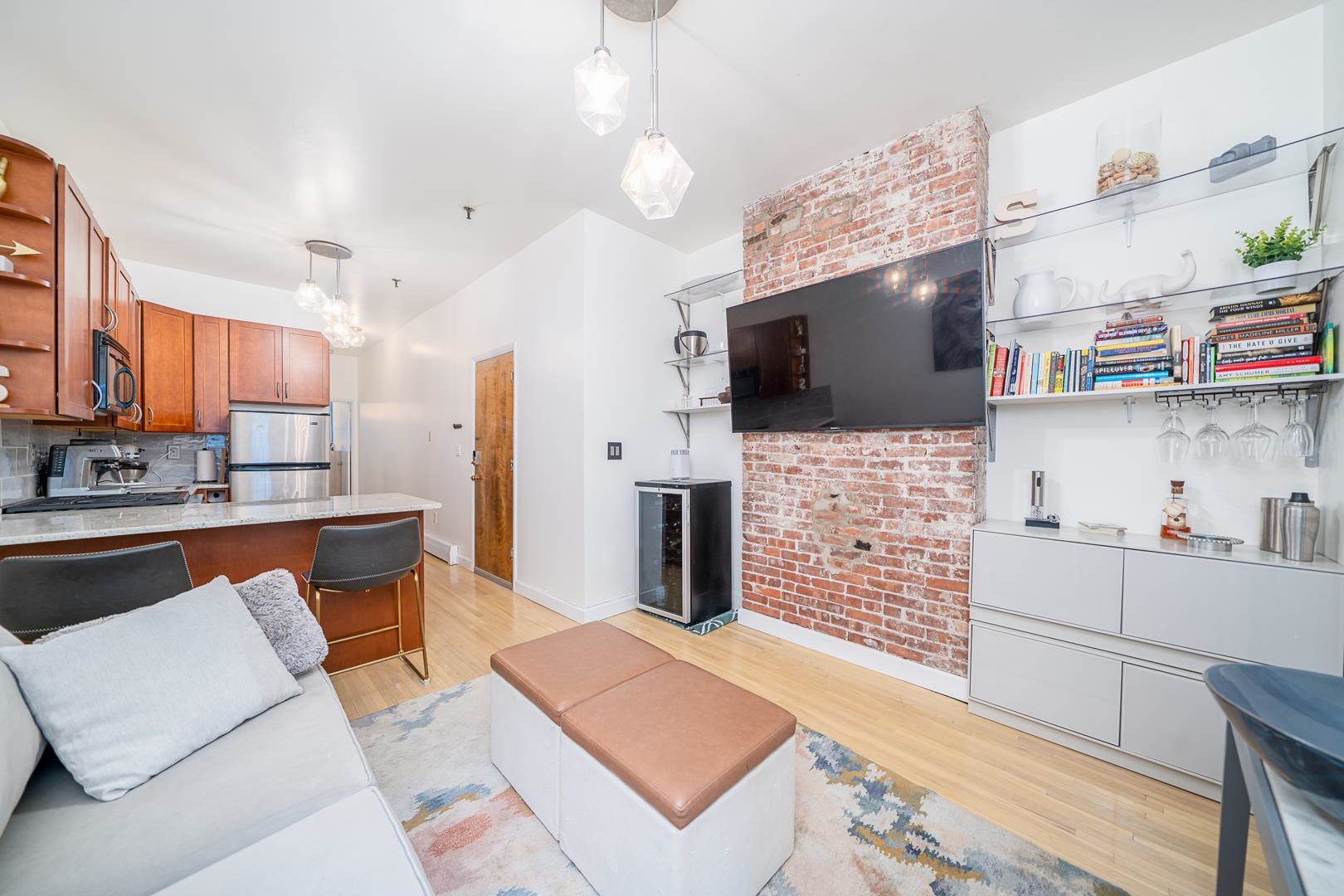 554 Observer Highway, Unit 1R Hoboken, NJ 07030 - Photo 6 of 21 a living room with fireplace furniture and a flat screen tv