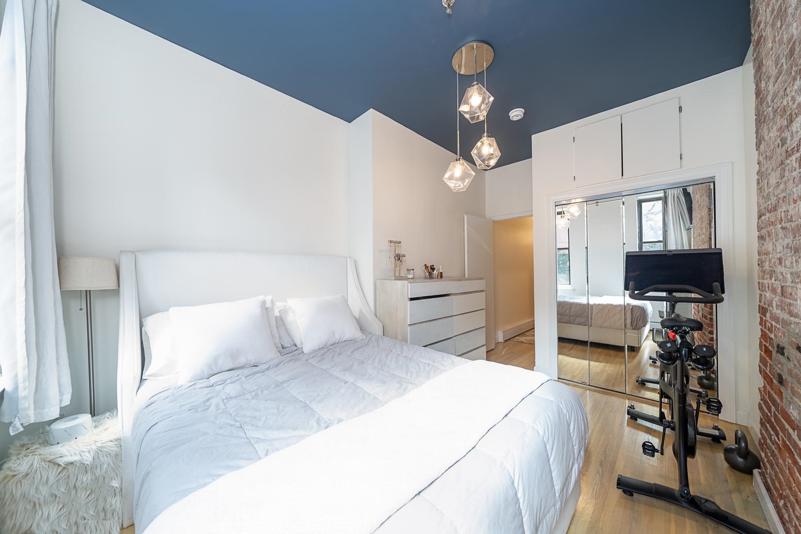554 Observer Highway, Unit 1R Hoboken, NJ 07030 - Photo 10 of 21 a bedroom with a bed and a chandelier