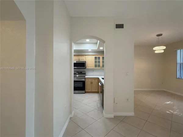 a view of a kitchen with a sink and dishwasher stove top oven with kitchen island