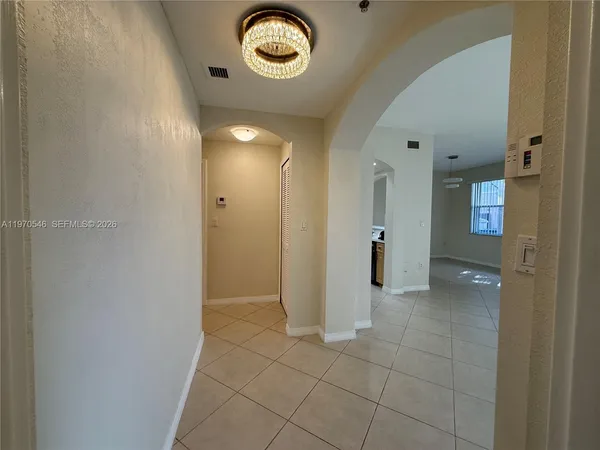 a view of a hallway with wooden shelves