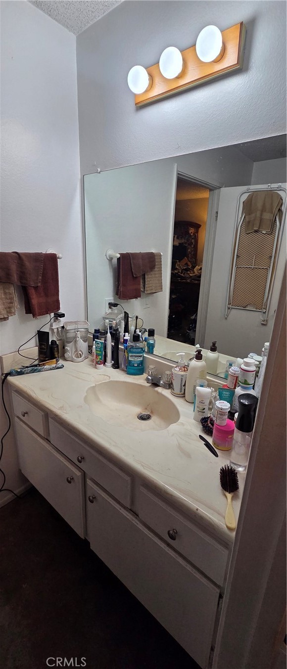 1548 Ranch Road San Bernardino, CA 92407 - Photo 21 of 26 a bathroom with a sink and a mirror