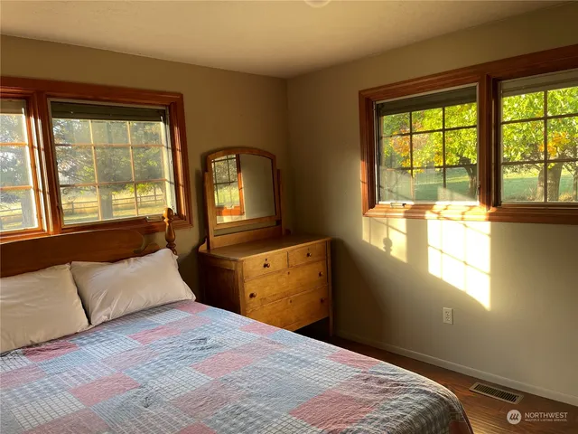a view of a room with wooden floor and windows