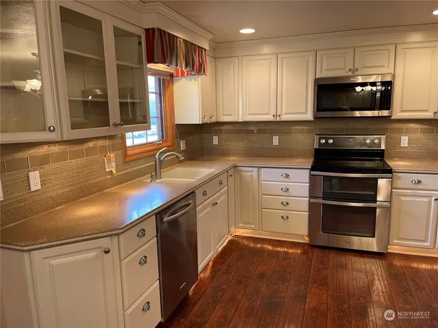 a kitchen with appliances cabinets and a sink