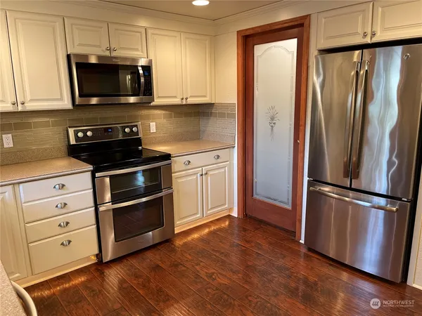 a kitchen with appliances and cabinets