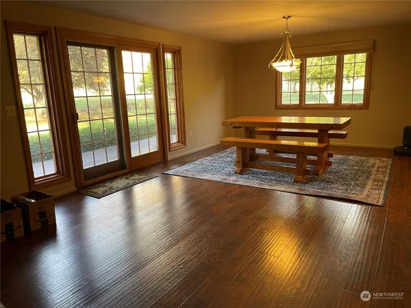 a room with wooden floor and a floor to ceiling window
