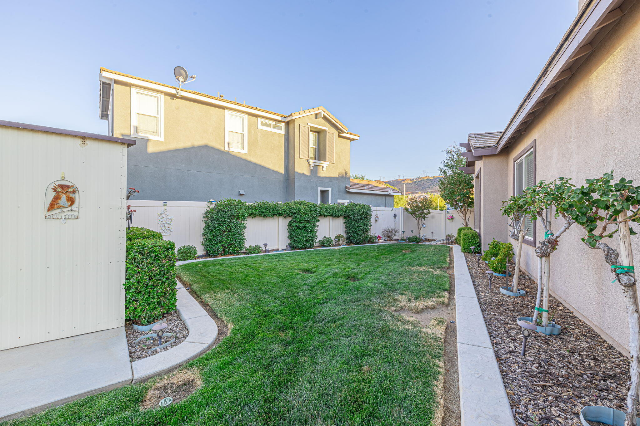 6827 Cabernet Road Palmdale, CA 93551 - Photo 44 of 50 a front view of a house with a yard and garage