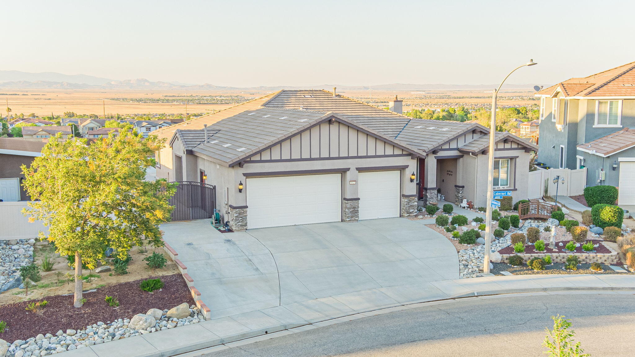6827 Cabernet Road Palmdale, CA 93551 - Photo 50 of 50 a front view of a house with a garden and balcony