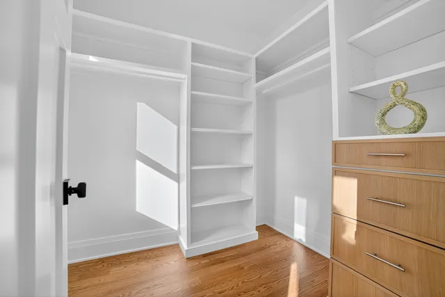 a view of walk in closet with empty racks