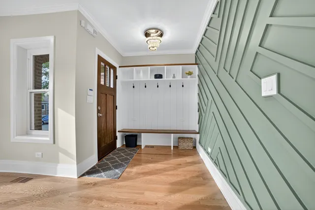 a view of a hallway with wooden floor and staircase