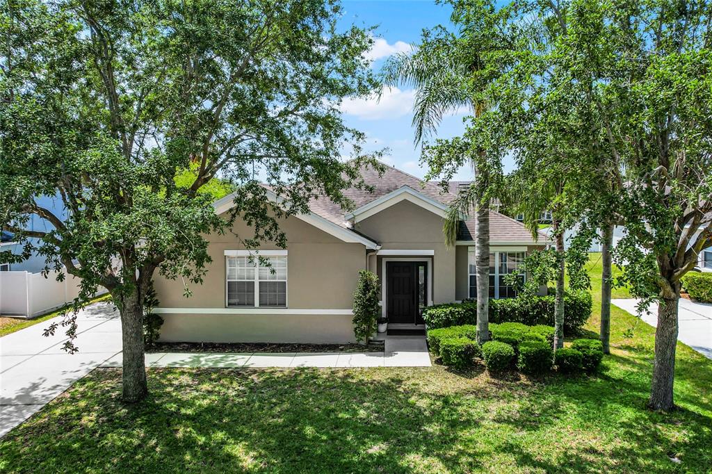 a front view of a house with a yard and porch