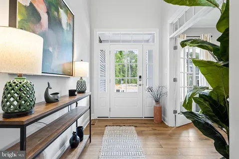 a kitchen with stainless steel appliances granite countertop a sink a stove a refrigerator and a window