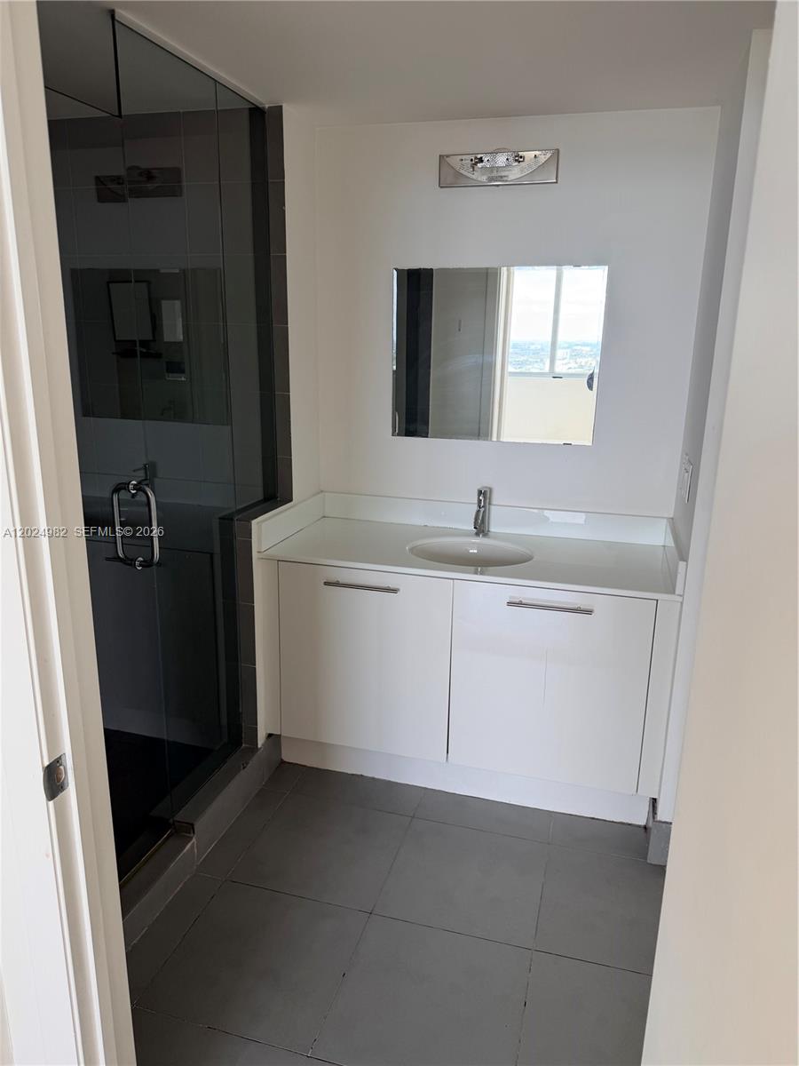 92 Southwest 3rd Street, Unit 3909 Miami, FL 33130 - Photo 6 of 13 a bathroom with a sink and a mirror