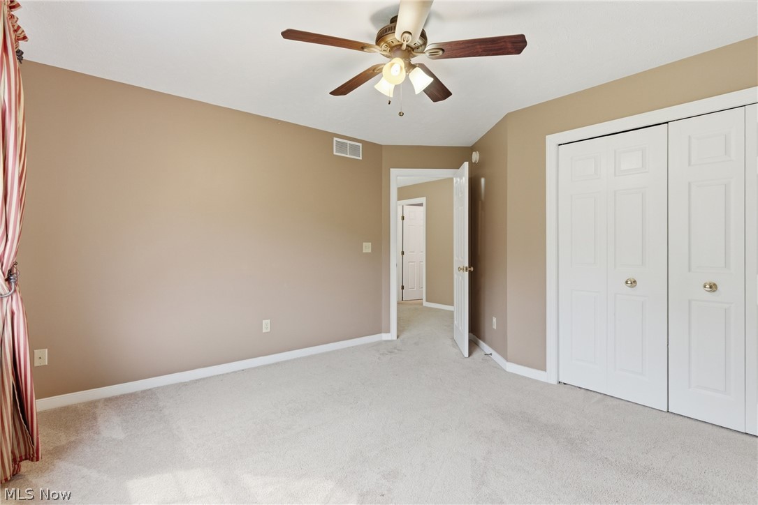 11678 Dunham Road Northfield, OH 44067 - Photo 22 of 38 Spacious room featuring neutral carpeting, a ceiling fan with integrated lighting, and two paneled bifold closet doors