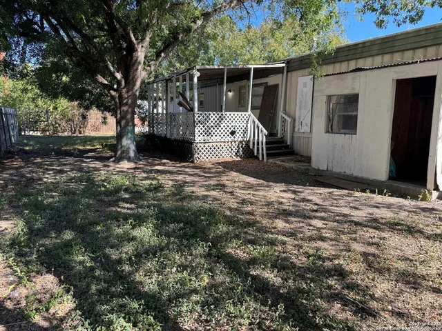 a view of a house with a tree in the background
