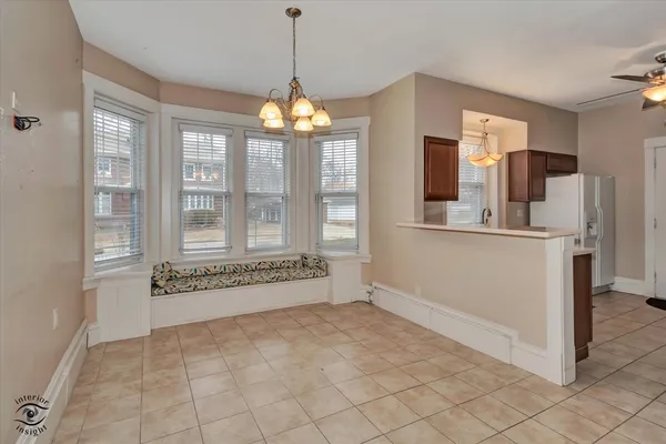 a view of kitchen with granite countertop cabinets and refrigerator