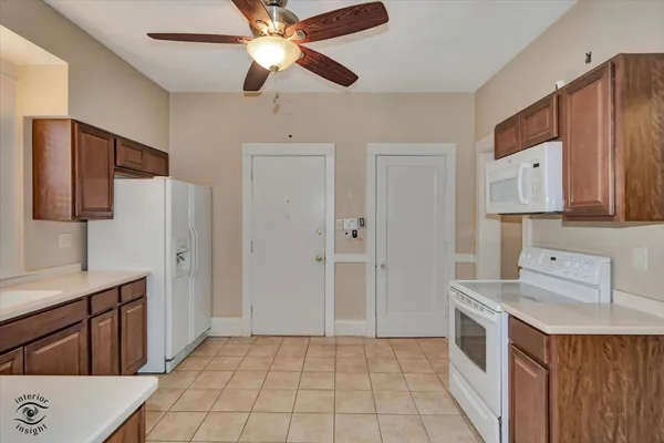 a kitchen with a stove a refrigerator and cabinets