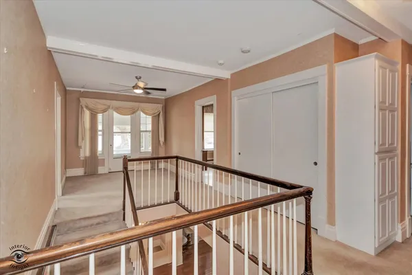 a view of staircase with wooden floor and fan