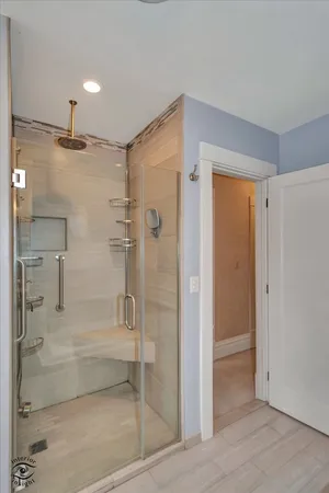 a bathroom with a shower and a glass door