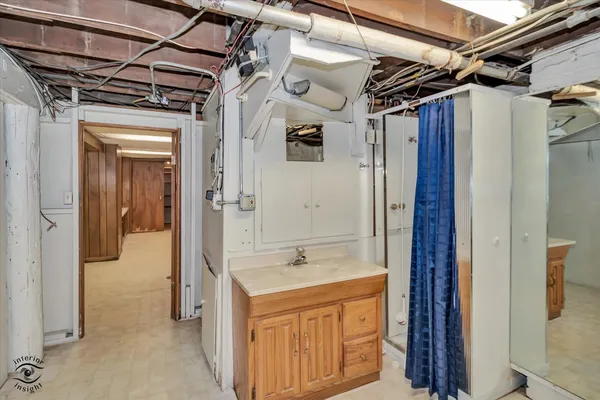 a bathroom with a shower sink and mirror