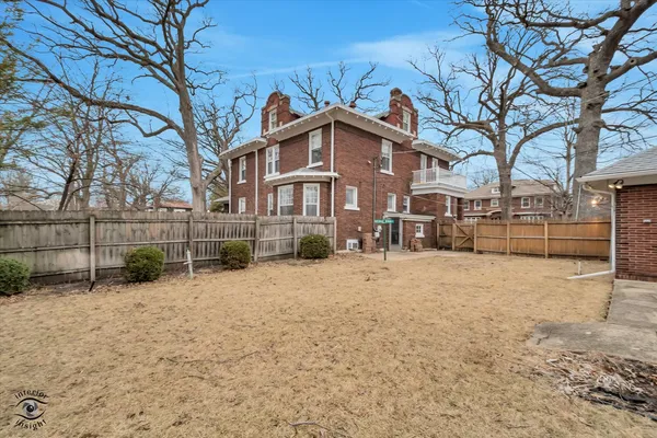 a view of a house with a yard covered in snow