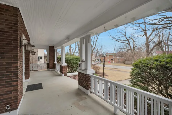 a view of a porch with furniture and floor to ceiling window