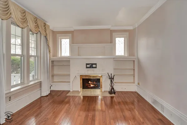 a living room with a fireplace and wooden floor