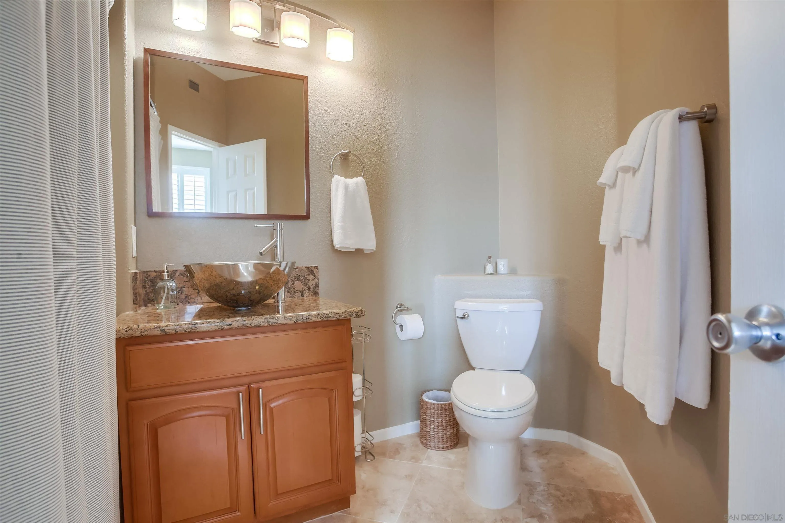 382 Carmel Creeper Place Encinitas, CA 92024 - Photo 24 of 43 a bathroom with a toilet sink and mirror
