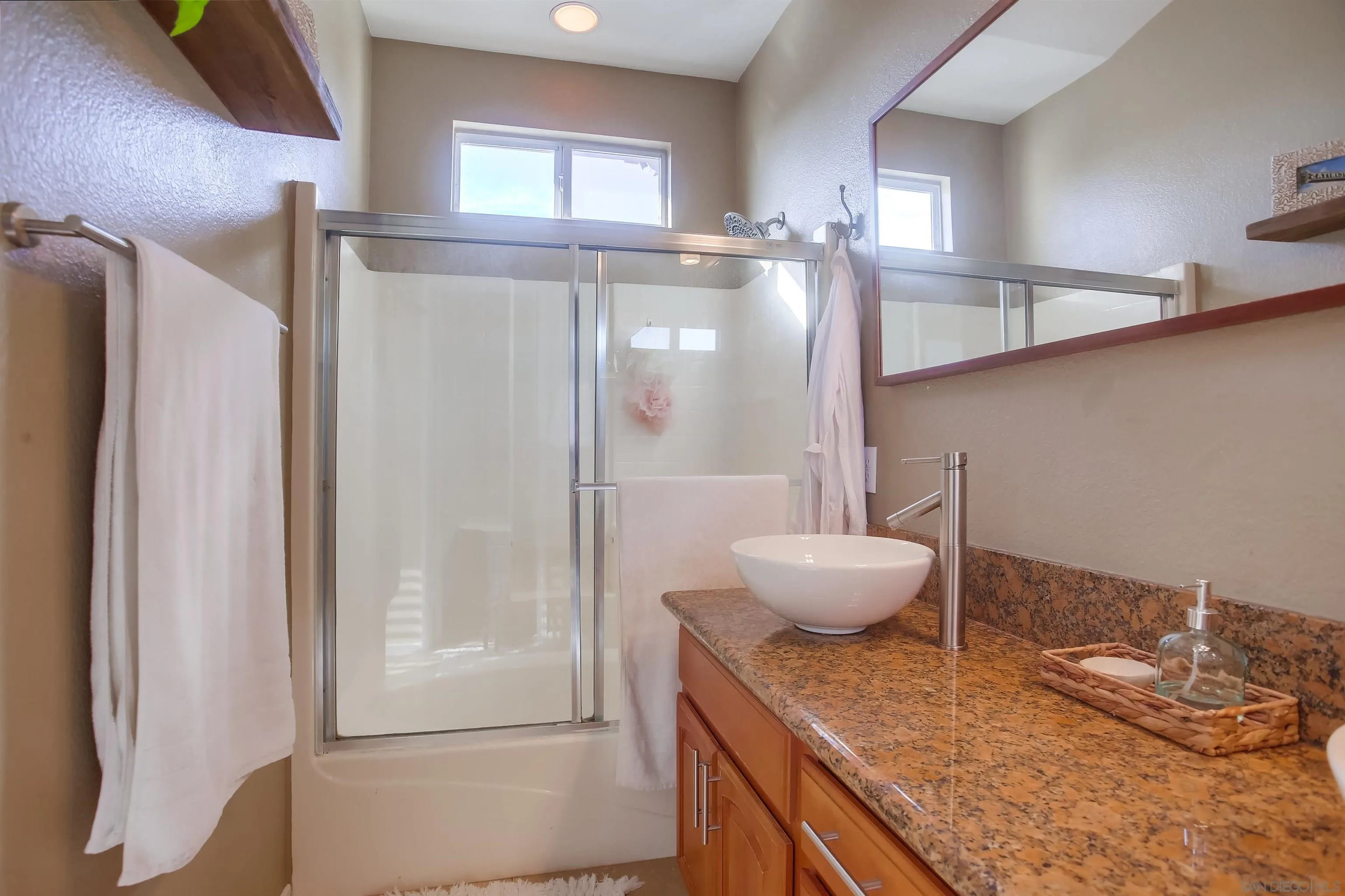 382 Carmel Creeper Place Encinitas, CA 92024 - Photo 30 of 43 a bathroom with a granite countertop sink a toilet and a mirror
