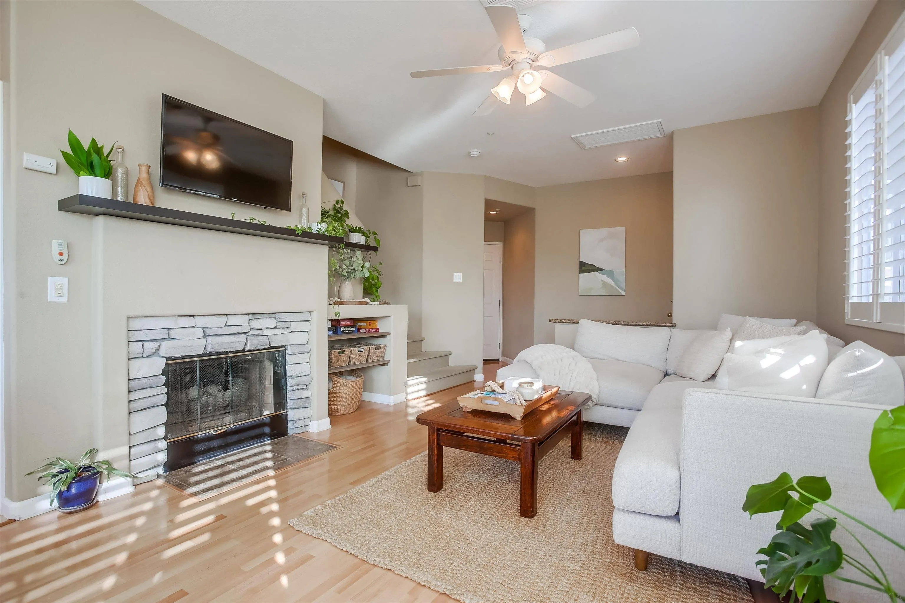 382 Carmel Creeper Place Encinitas, CA 92024 - Photo 7 of 43 a living room with furniture a fireplace and a flat screen tv