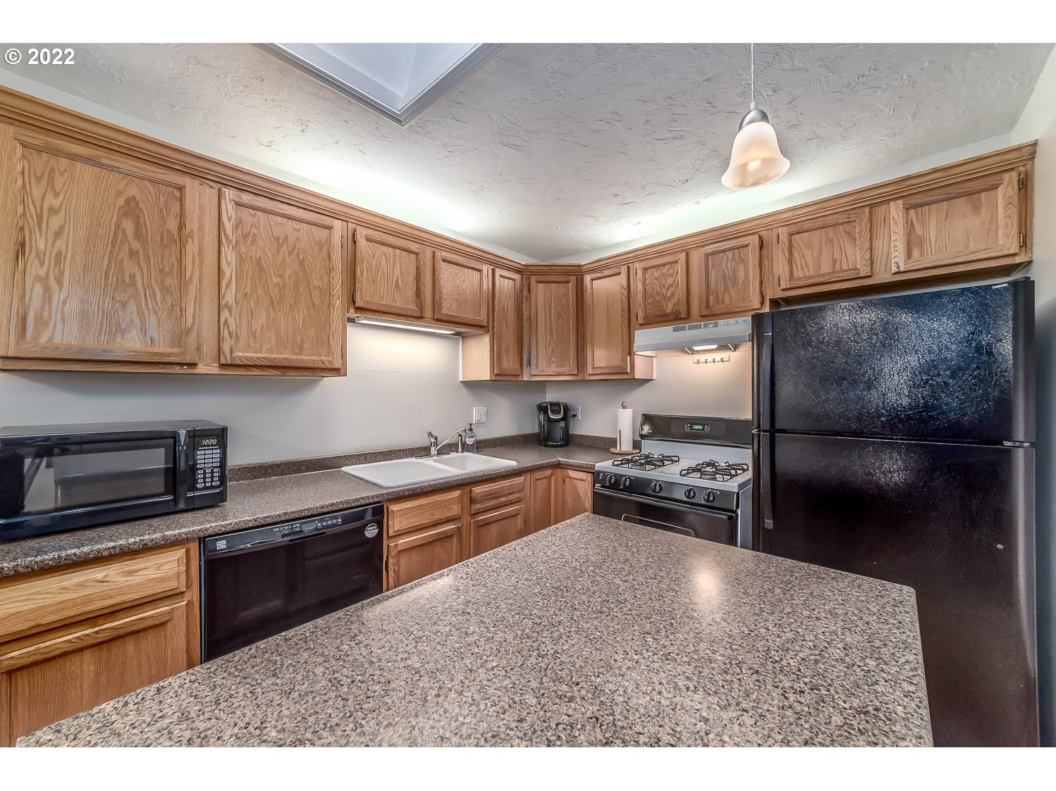 331 South 46th Street Springfield, OR 97478 - Photo 12 of 28 a kitchen with granite countertop a refrigerator stove top oven and sink