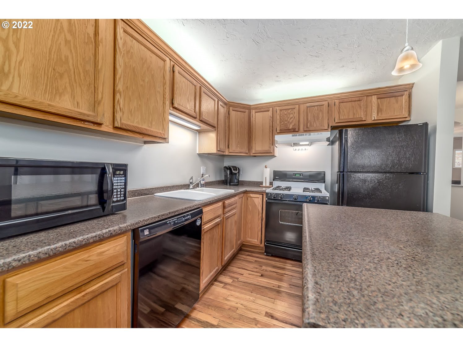 331 South 46th Street Springfield, OR 97478 - Photo 15 of 28 a kitchen with granite countertop a sink cabinets stainless steel appliances and a counter top