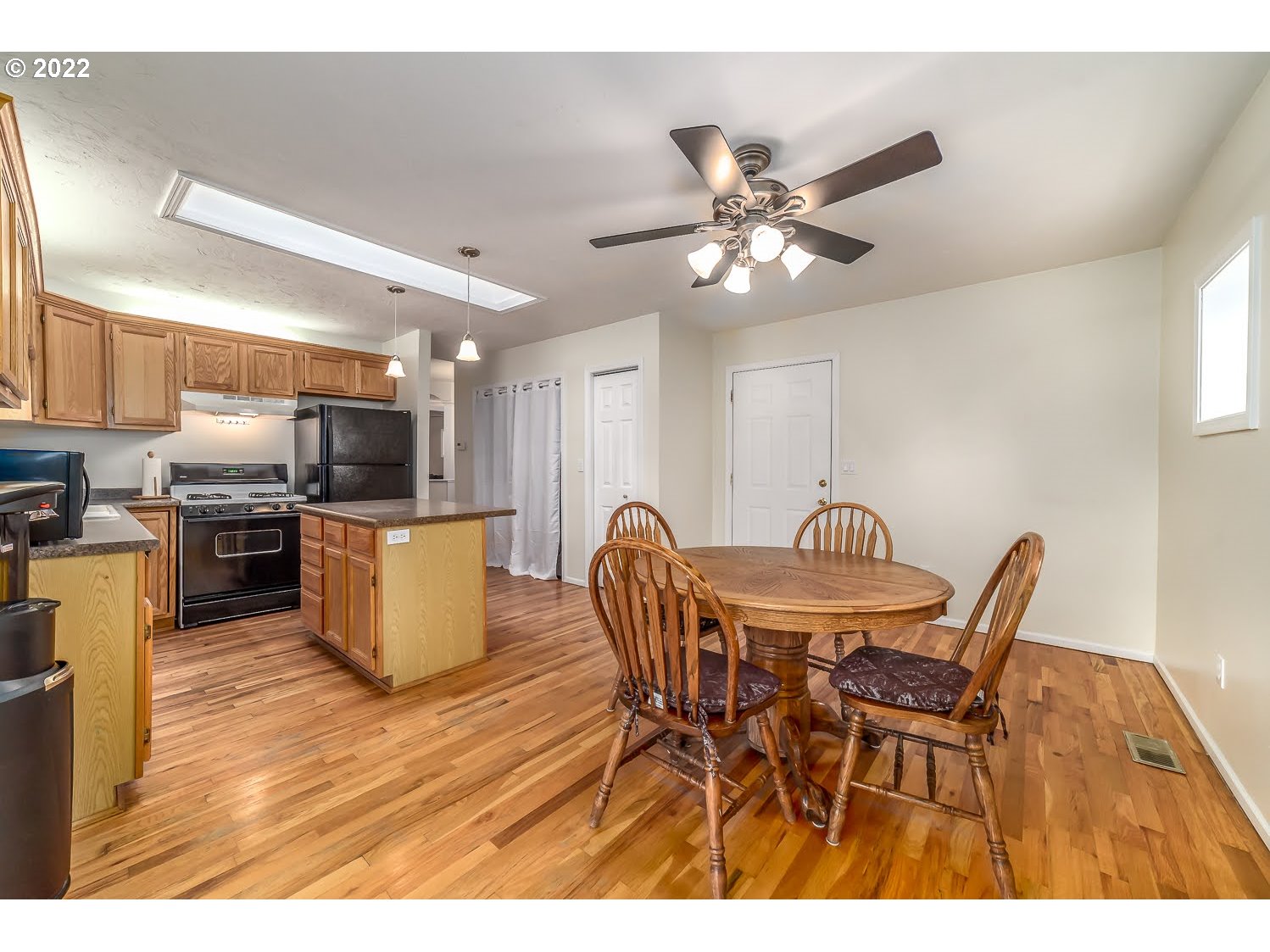 331 South 46th Street Springfield, OR 97478 - Photo 16 of 28 a view of a dining room with furniture and wooden floor