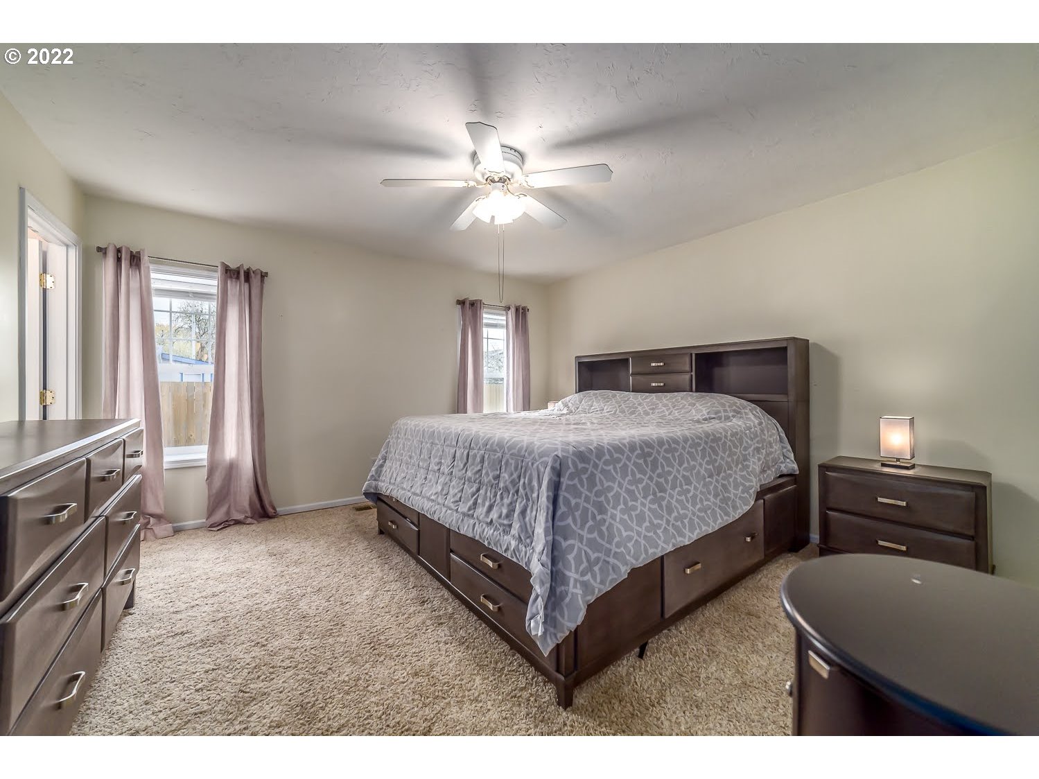 331 South 46th Street Springfield, OR 97478 - Photo 17 of 28 a bedroom with a bed and a chandelier