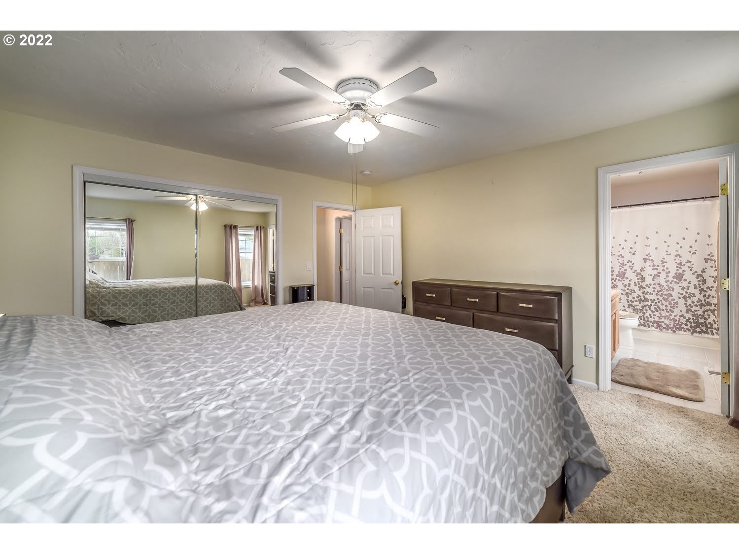 331 South 46th Street Springfield, OR 97478 - Photo 18 of 28 a bedroom with a large bed and a chandelier
