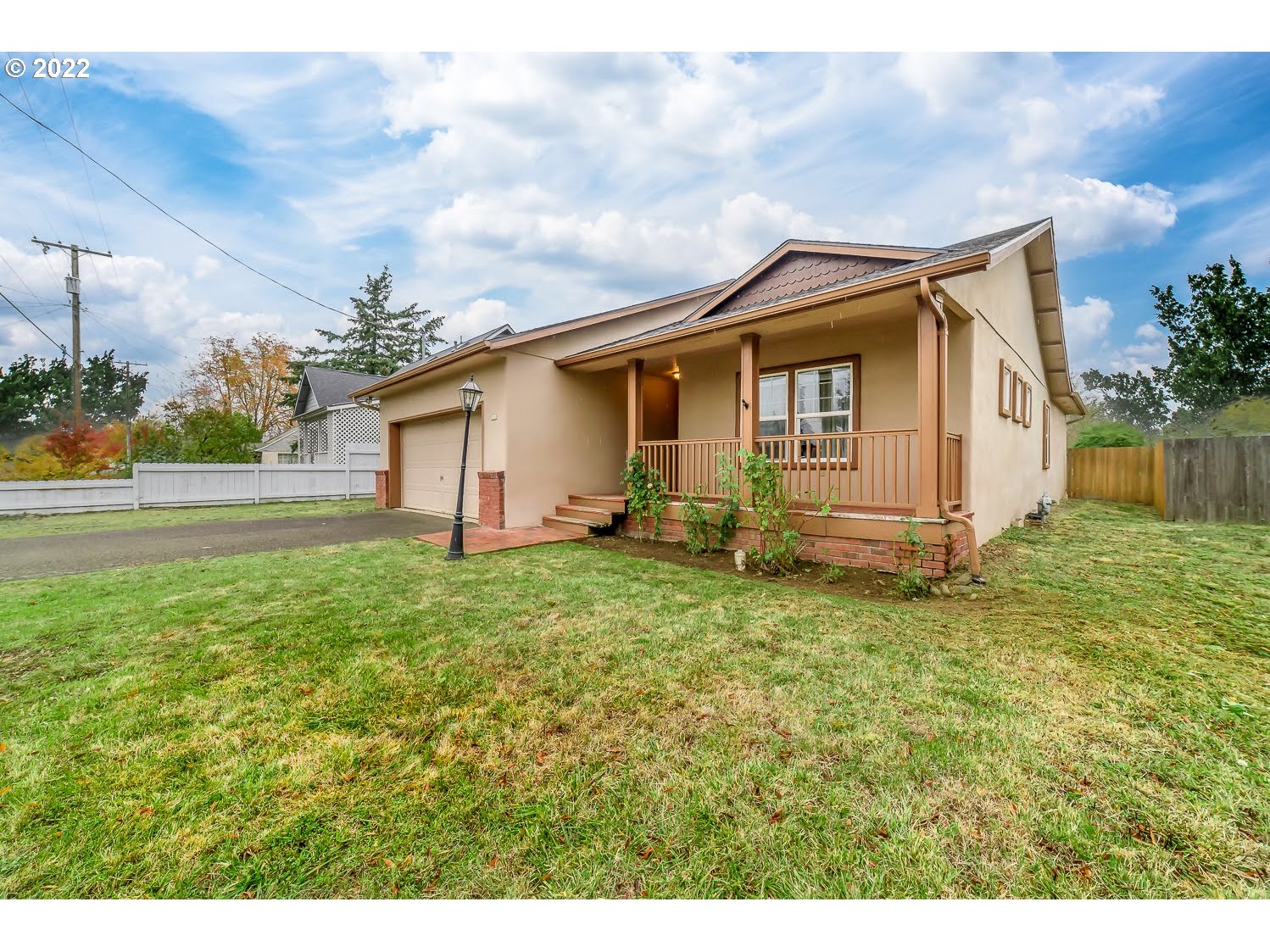 331 South 46th Street Springfield, OR 97478 - Photo 2 of 28 a small house with a big yard and large trees