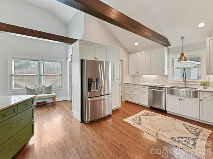 a kitchen with a sink appliances and cabinets