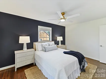 a bedroom with a bed and a lamp on table