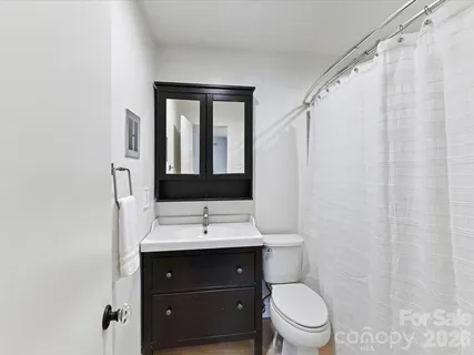 a bathroom with a toilet a sink and a mirror