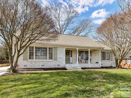 a front view of house with yard and trees