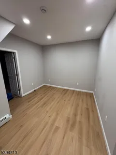 an empty room with wooden floor and a window