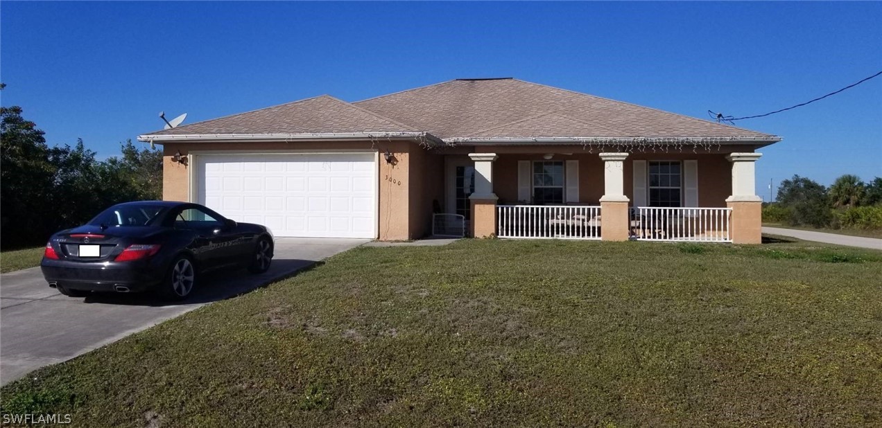 a front view of a house with a garden and yard