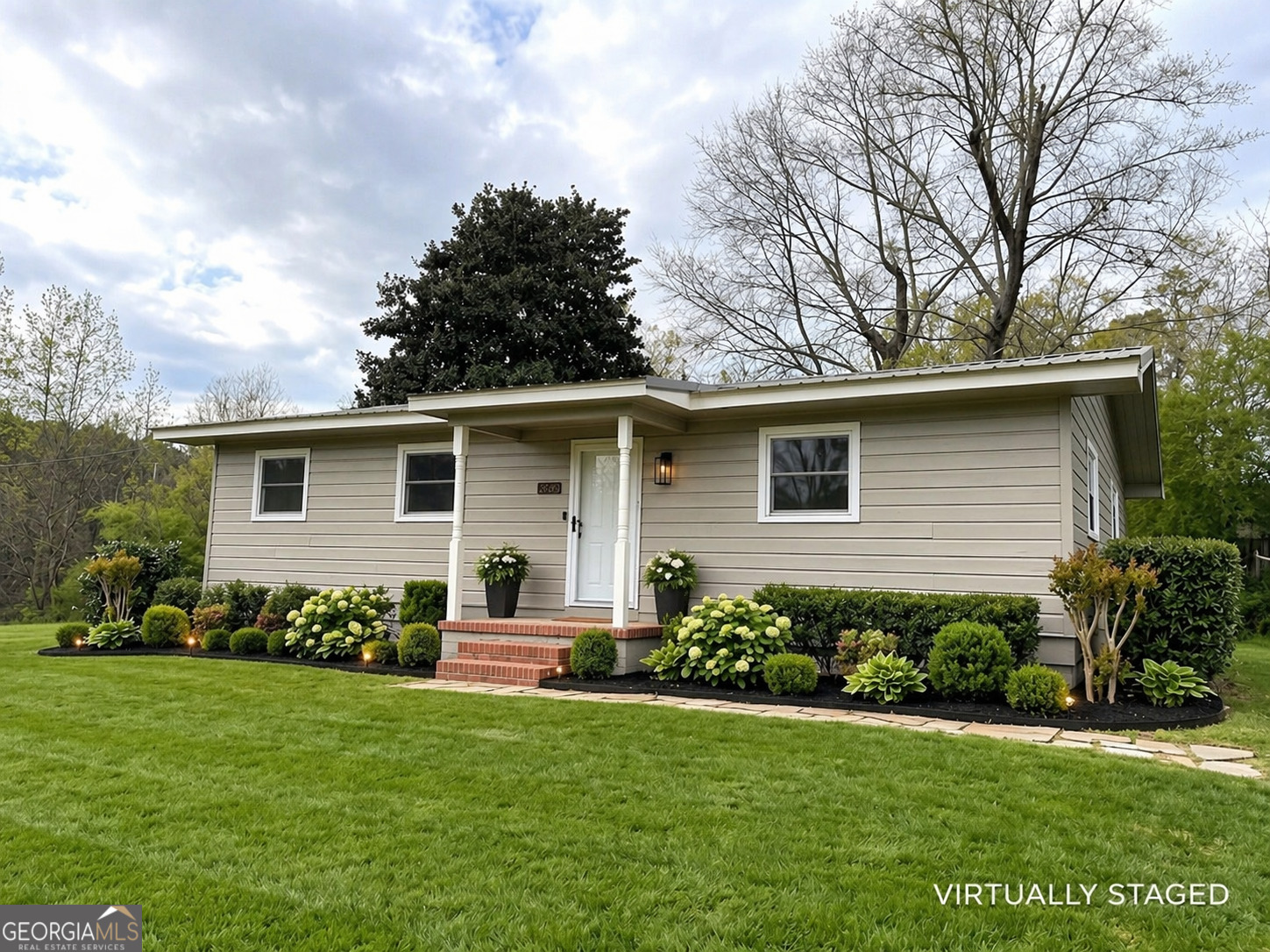 605 Perryman Bridge Road Heflin, AL 36264 - Photo 2 of 52 a front view of a house with a garden