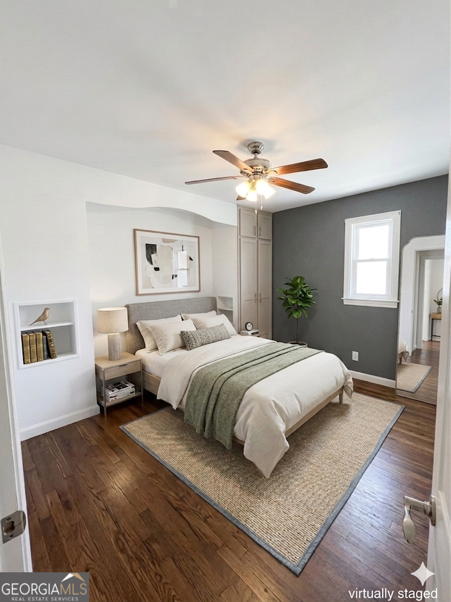 605 Perryman Bridge Road Heflin, AL 36264 - Photo 23 of 52 a bedroom with a large bed and a chandelier
