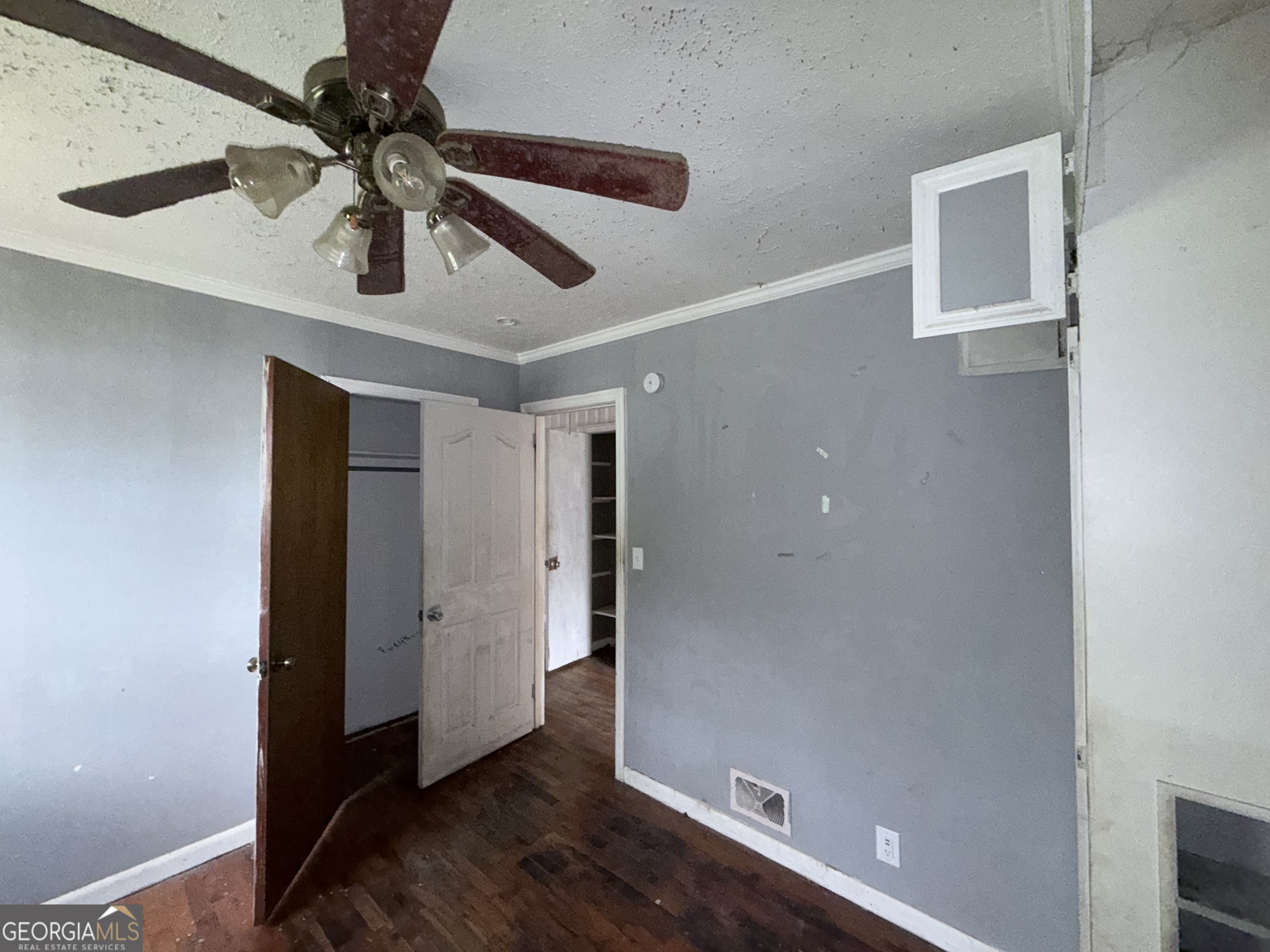 605 Perryman Bridge Road Heflin, AL 36264 - Photo 24 of 52 en empty room with wooden floor and ceiling fan