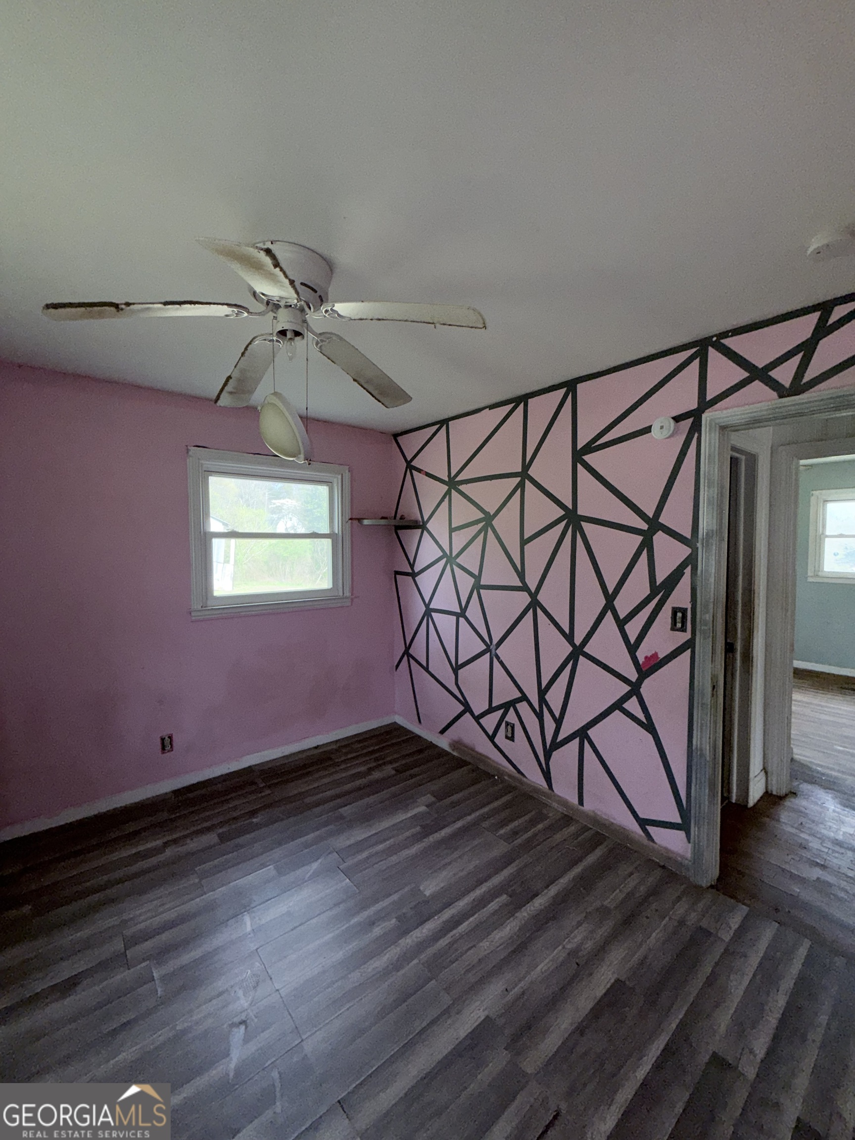 605 Perryman Bridge Road Heflin, AL 36264 - Photo 26 of 52 a view of a livingroom with hardwood floor and a ceiling fan