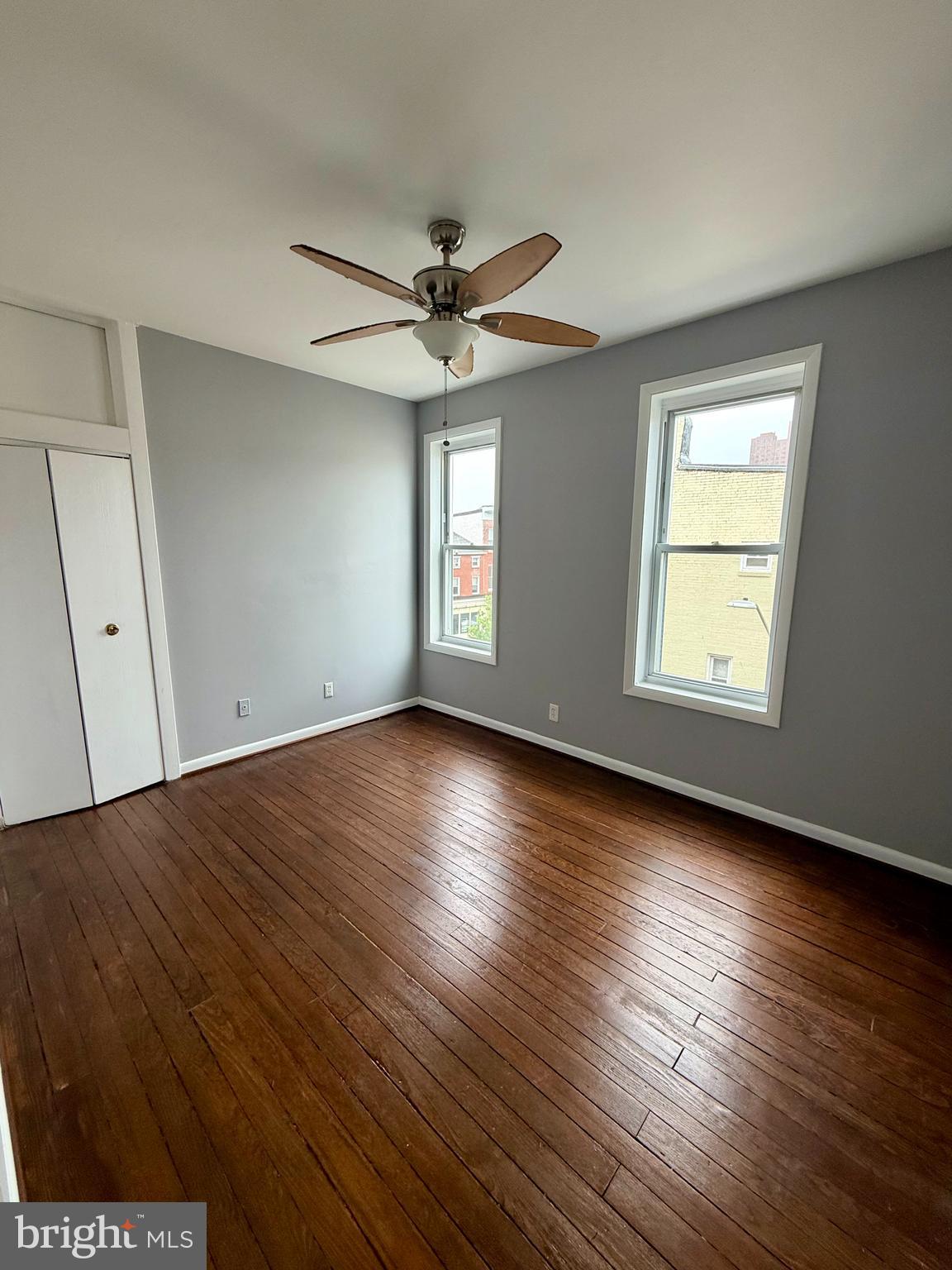 1001 Light Street, Unit 3 Baltimore, MD 21230 - Photo 10 of 14 an empty room with wooden floor and windows