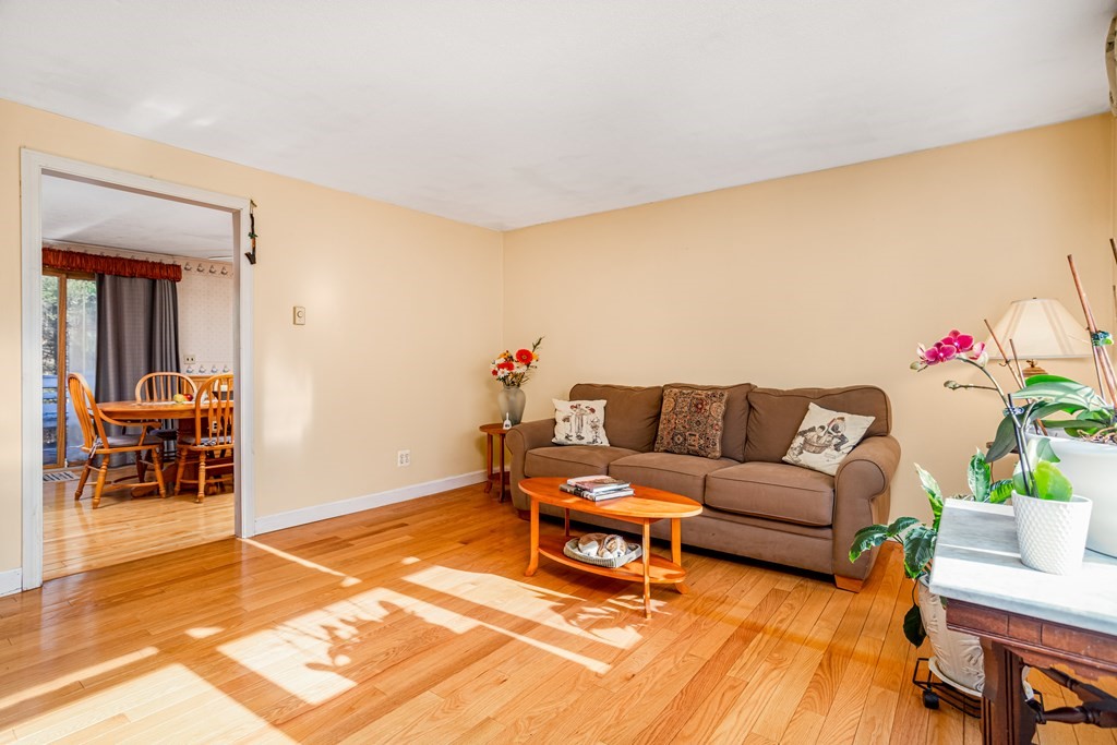 155 Groton Road Shirley, MA 01464 - Photo 12 of 42 a living room with furniture and a dining table with kitchen view