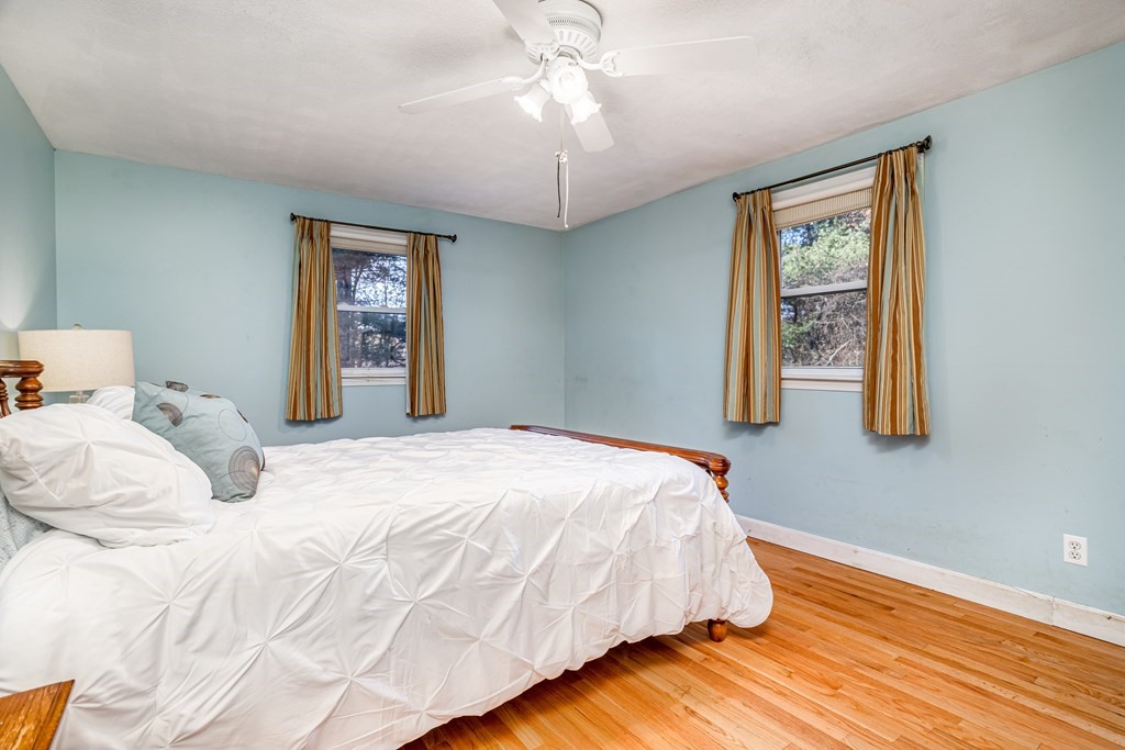 155 Groton Road Shirley, MA 01464 - Photo 15 of 42 a bedroom with a bed and a chandelier